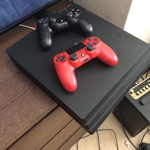 PlayStation 4 pro with 2 controllers and 4 games